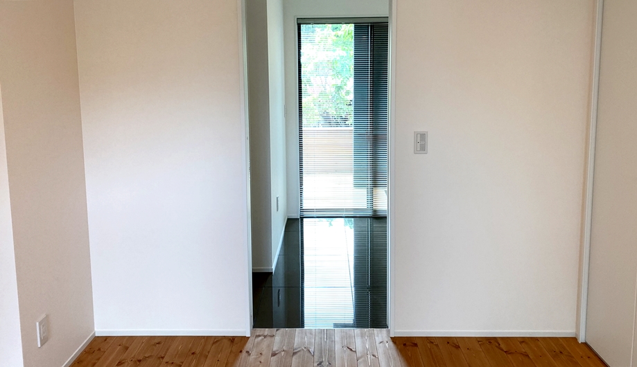 寝室からサニタリーをのぞむ。日の光をうけて輝くタイルがアメニティを演出する。